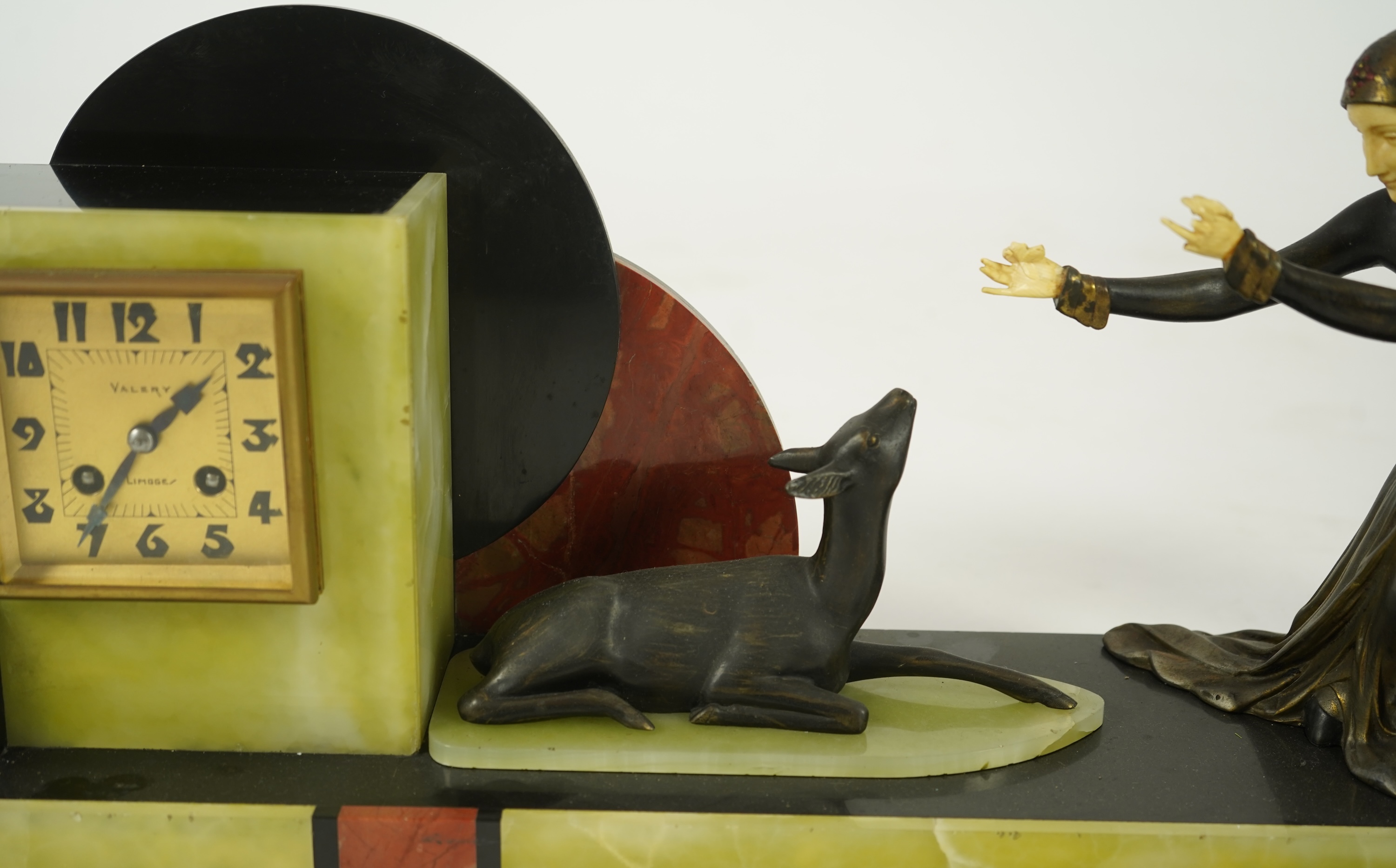 Attributed to Uriano (Ugo Cipriani, Italian, 1897-1960), a Belgian black marble, Rosso red marble and green onyx clock garniture
